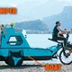 A photo of the Z-triton camper trike being ridden near a lake.